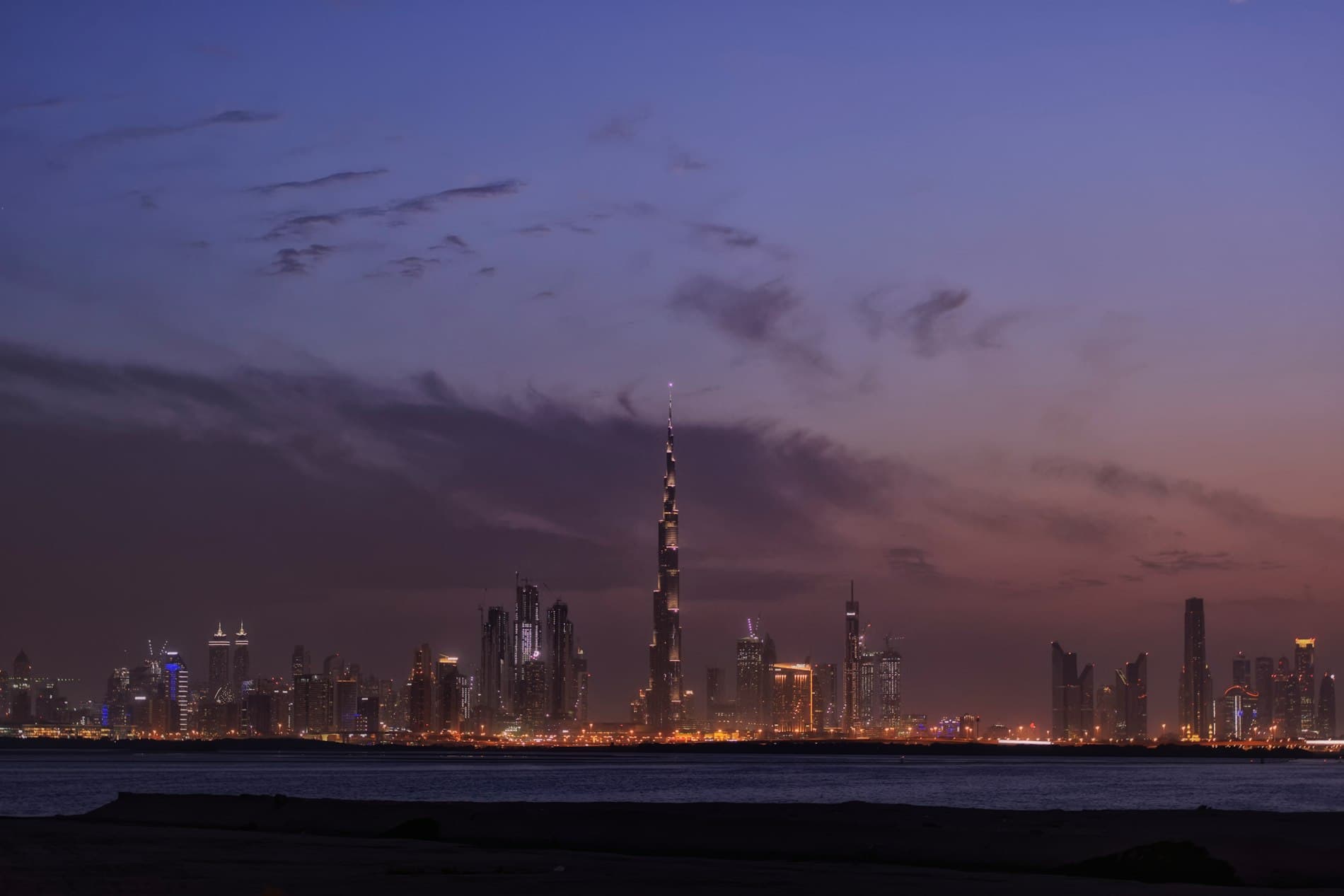 City skyline at night across open water
